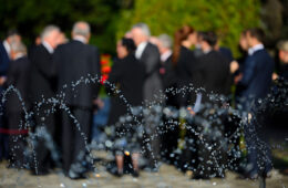 Blurred people in black suits on funeral