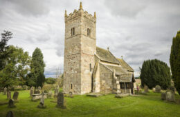Church exterior, Holy Trinity Norman church in Little Ouseburn, Yorkshire, UK