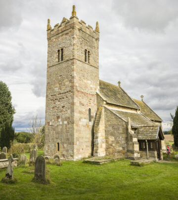 Church exterior, Holy Trinity Norman church in Little Ouseburn, Yorkshire, UK